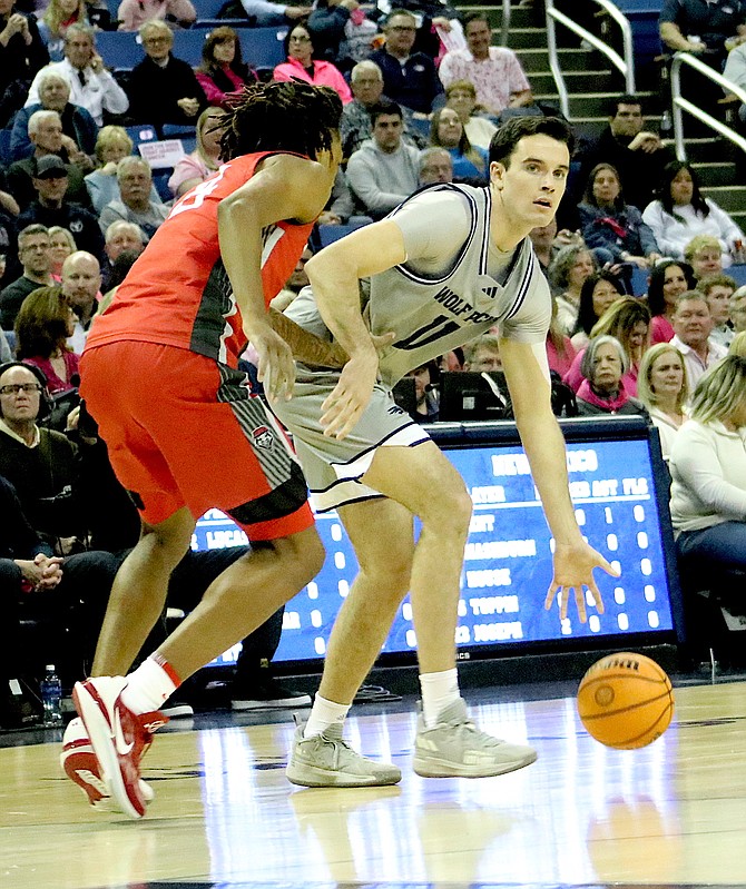 Wolf Pack forward Nick Davidson looks for an open teammate in Nevada’s Mountain West Conference basketball game against New Mexico. The Lobos edged Nevada 83-82 thriller Tuesday night at Lawlor Events Center.