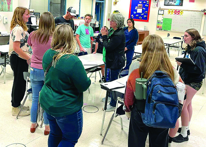 Churchill County High School students and their families meet with Elaine Adams during the fall open house.