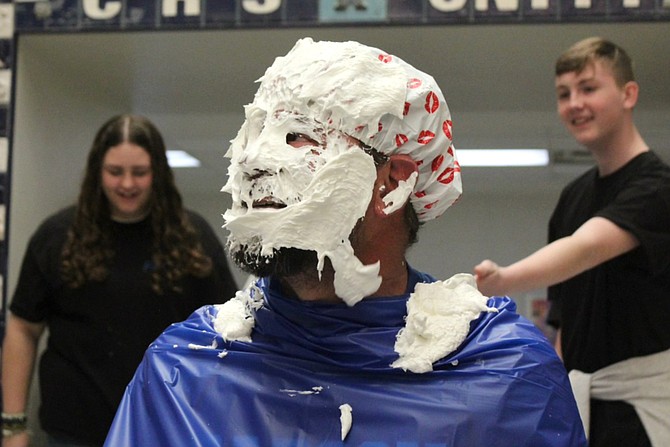 Carson High School Dean Matt Morgan looks up after taking a pie to the face for charity.
