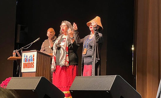 Jennifer Bereskin-SeaMonster and Čəlalakəm SeaMonster (in hat) address the audience of the anti-hate forum Thursday, Oct. 26 at the Everett Civic Auditorium. Forum host Kevin Henry stands behind at the podium.