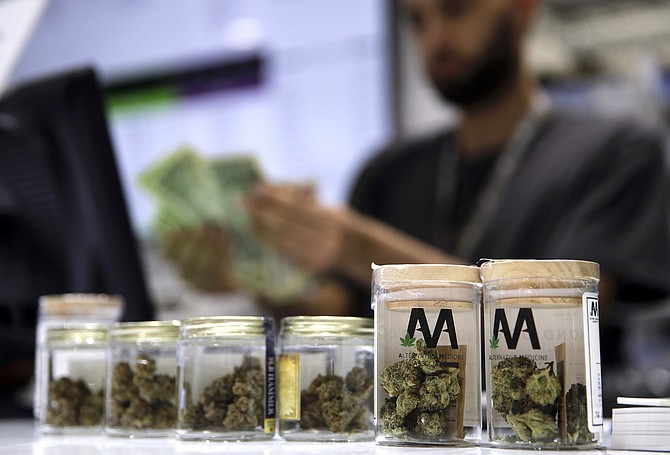A cashier rings up a marijuana sale at a cannabis dispensary in Las Vegas on July 1, 2017.