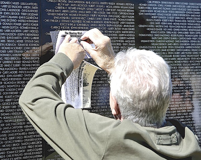 A Carson City Vietnam veteran takes an impression of the names of members of his unit at The Moving Wall on June 1, 2018, at Eastside Memorial Park in Minden.