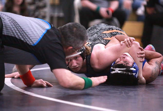 Douglas High senior Aaron Tekansik looks for a pin at the Class 5A North regional tournament. Tekansik was chosen as a first team all-region wrestler at 190 pounds for the second consecutive season.