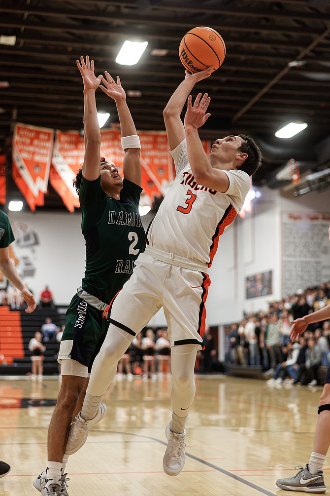 Douglas High junior point guard Caden Thacker takes an off-balance shot against Damonte Ranch earlier this season. Thacker was chosen as a first team all-region player for the second year in a row.