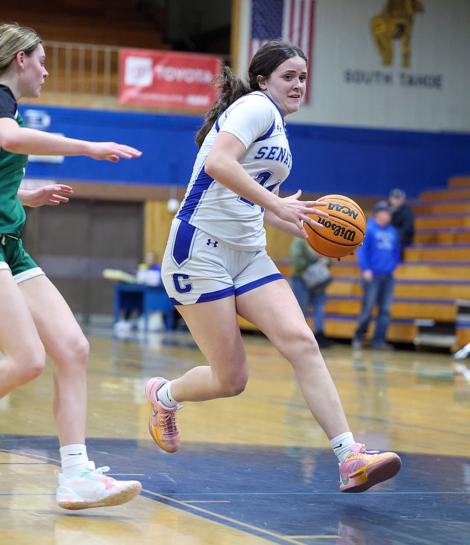 Carson High’s Lauren Finnerty dribbles around a Damonte Ranch defender this season. Finnerty was selected as a first team all-region player this winter, solidifying her second all-region team nod after being a second team selection last season.