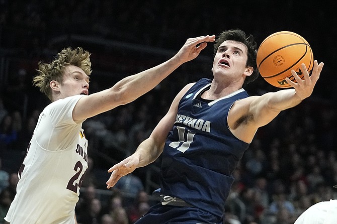 Nevada's Nick Davidson shoots against Arizona State's Duke Brennan during the teams’ NCAA Tournament game on March 15, 2023, in Dayton, Ohio.