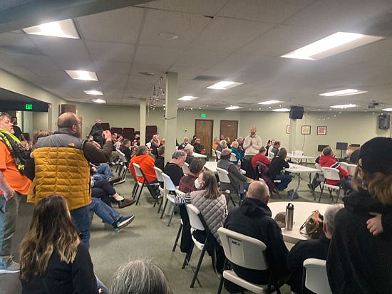 Dana Sullivan (in jacket) yells a frustrated plea at county human services planner Tyler Verda (standing at right) to not relocate homeless shelter services into the Glacier View Neighborhood during the Wednesday, April 5 meeting in the basement of Hope Church.