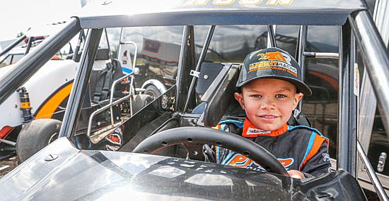 Hudson Johnson, 8, stands next to his race car at Monroe's quarter midget track this April.
