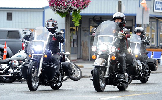 A group of motorcyclists pass by a few of the early arrival bikes as they ride up First Street in Snohomish heading in for the Sky Valley Motorcycle Show in fall 2021. While the weather saw drizzles in the morning, it took until midday for the event to get into full swing.