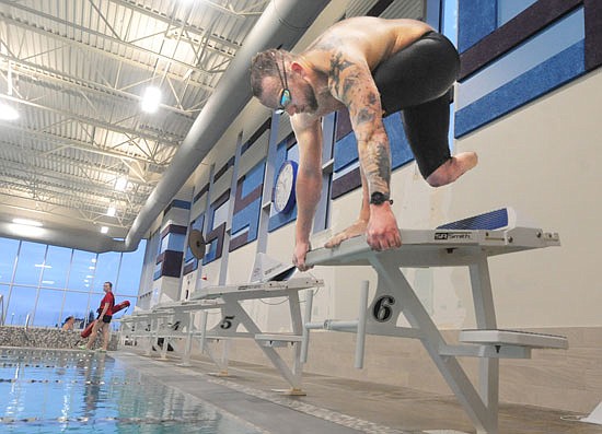 James Hessen, 33 of Marysville, prepares to dive into the pool during an early morning session at the Everett YMCA last week.