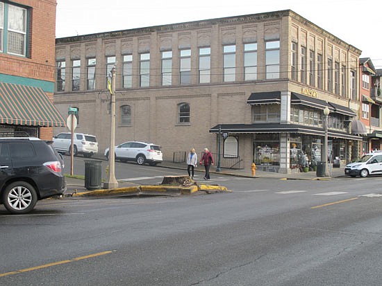 The area around a removed tree has raised pavement and curbs the city wants to address before thinking of replacement plants.