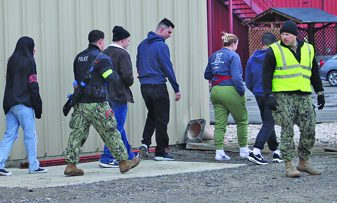 Freed 'hostages' are led away from a building at Naval Air Station Fallon during the recent Citadel Shield Solid Curtain 2024 force protection exercise.