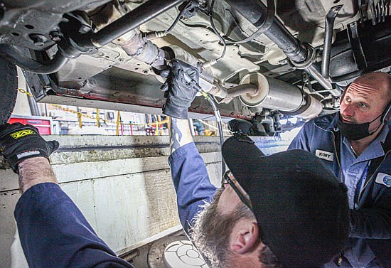 City of Everett employee Jason McCarter engraves the vehicle’s VIN number on its catalytic converter. McCarter, a 22-year-employee of the City of Everett, is assisted by Kory Bustad at the Jan. 8 CatCon ID event held by Everett Police.