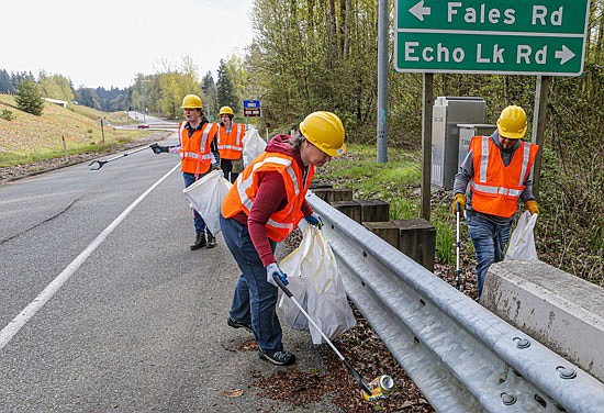 Area residents Amy Schlesener, Megan and Scott Andrews and Kim Westerhof, all in the photo, were among dozens who worked to collect trash and litter along the Echo Lake / Fales Road highway ramps to state Route 522 on Saturday, April 23. By that afternoon there were many bags of collected litter awaiting pickup as part of the state Adopt-a-Highway program.