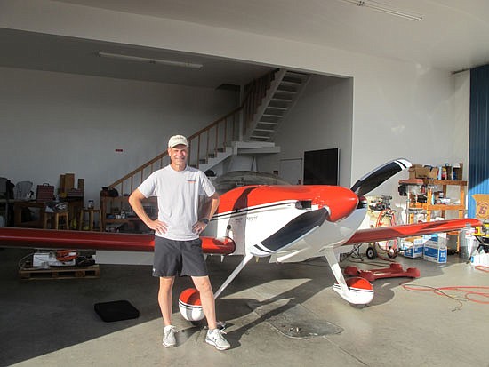 Stephen Christopher, 58, of Monroe stands in a hangar at the Arlington airport next to his two-seater RV-7 airplane which he built himself. He flies it for travel, pleasure and coordinated stunt flying as part of Undaunted Airshows, the tandem stunt team he and Todd Rudberg
formed. Rudberg flies a home-built RV-8 model.