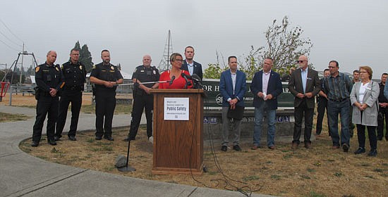Everett Mayor Cassie Franklin introduces the coalition at a press conference at Everett’s Henry M. Jackson Park on Tuesday, Oct. 4. To her right, from left to right, are Sultan Mayor Russell Wiita, Marysville Mayor Jon Nehring, Lake Stevens Mayor Brett Gailey, and other elected leaders. To the left are four police chiefs, including Dan Templeman of Everett (far left), Erik Scairpon of Marysville (third left) and Jeff Beazizo of Lake Stevens (fourth left).