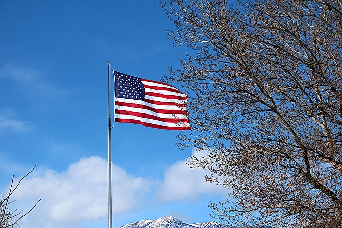 The wind lofts the flag over Minden Park.