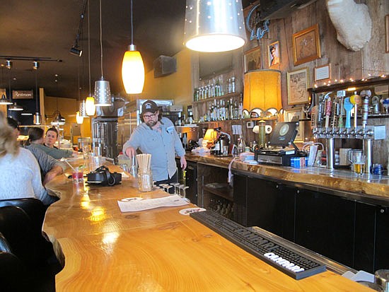 Pie Dive Bar’s co-owner Hart Kingsbery grabs a glass to pour a drink for a customer in the bar last week.
