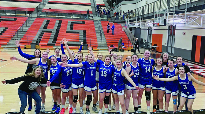 The Eatonville girls basketball team, along with coaches and cheerleaders, pose following their 40-36 upset victory over the Seton Catholic Cougars.
