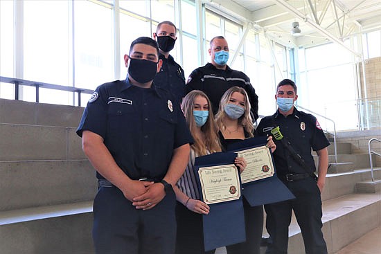 Snohomish Aquatic Center lifeguards Grace Rhodes (right) and Hayleigh Tramm (left) received awards May 21 for using CPR and a defibrillator to rescue a boy from the pool.