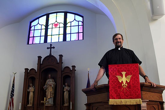 The Rev. Don Stults poses for a photo at the pulpit of Zion Lutheran Church in Snohomish on Friday, June 25, fresh from relocating from Colorado.