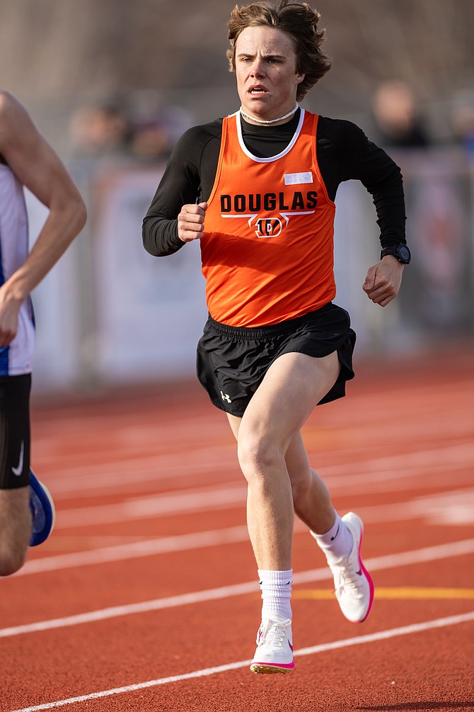 Douglas High’s Luke Davis hits the straight during the 1,600-meter run Thursday afternoon at Douglas High School. Davis was second in the event in the Tigers’ season-opener.