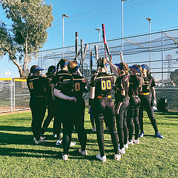 The Lowry High School softball team gets ready for a game at the Colorado River Invitational in Needles, Calif.,