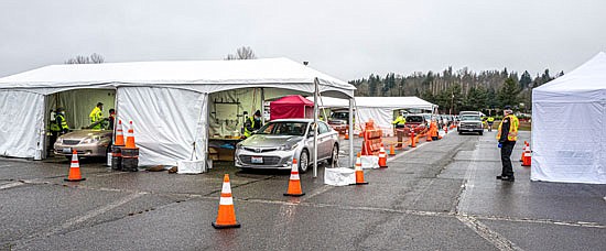 People waited in a long line on Friday, Jan. 15 to receive a COVID-19 vaccination at the pop-up site at the Evergreen State Fairgrounds.