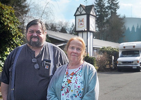 Chris and Carol Walsh stand in front of the clock tower that sits near the entrance to the Delta Rehabilitation Center off of Terrace Avenue.