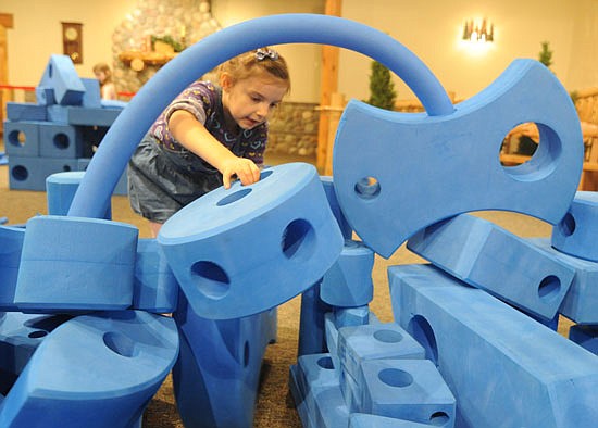 In November when the museum was open, Baylynn Fox of Everett slid foam blocks through the doorway of a castle that she and her sister Calla, 3, built using the Imagination Playground Blocks in the Build Zone.
