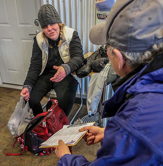 Katie, a former worker at Take the Next Step and now homeless, answers the Point In Time questionnaire with volunteer Mike Glaser, of Snohomish, on Thursday morning in the Monroe laundromat on Main Street.