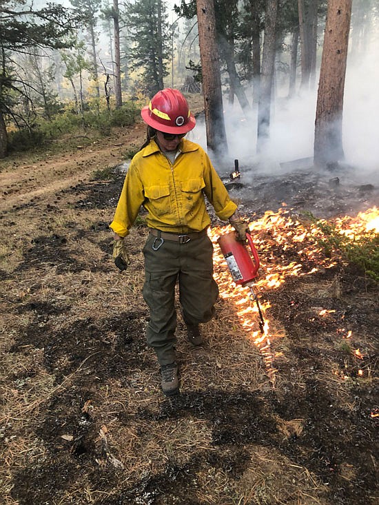 Sammie Davis assists the Bitterroot Hotshots with a backburn on the Cameron Peak Fire in Colorado in August.