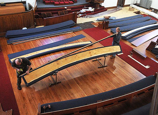 Jack Pacheco (left) and James Thompson assemble one of the new pews at the Zion Lutheran Church in Snohomish on March 13.
