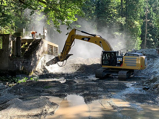 Workers use heavy machinery to demolish and remove the remaining structures in late July. Once used to collect drinking water for the town of Snohomish, removal of the dam will allow fish populations to move up river with greater ease.