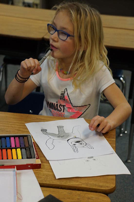 Addi Dormaier, 7, considers next steps for her drawing of the movie character Bolt.