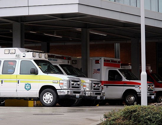 Ambulances from private ambulance companies Rural Metro and Falck line up in front of the ambulance bay at Providence Regional Medical Center Everett in 2015. The two companies, along with American Medical Response and Northwest Ambulance, are the four private companies that operate in Snohomish County. Everett Fire is increasing its own rates to more closely match the prices charged by other area fire districts.