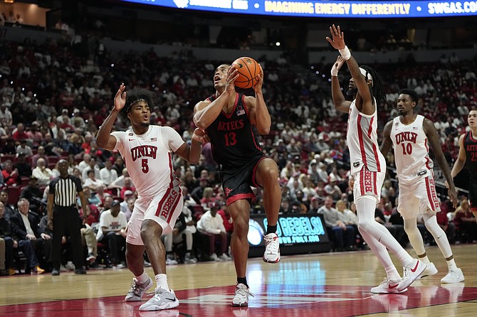 San Diego State’s Jaedon LeDee (13) goes up for a shot between UNLV defenders during the Rebels’ win on March 5.