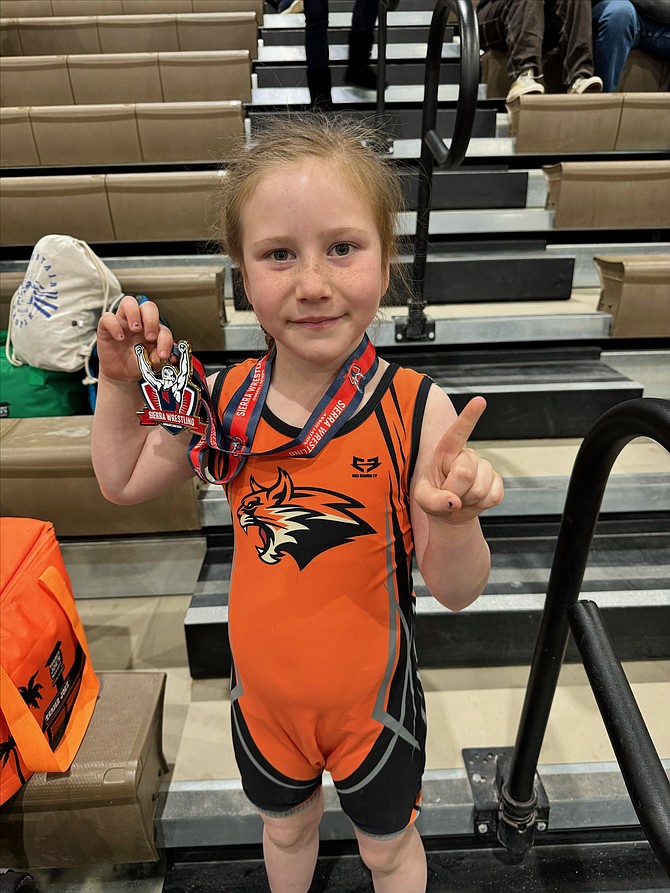 Josie Thomsen holds her medal after winning the 6-and-under 48-52 pound weight class at the SWA regional championships.