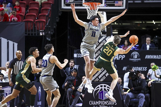 Nevada forward Nick Davidson (11) defends against Colorado State guard Joe Palmer (20) during the quarterfinals of the Mountain West men's tournament on March 14.