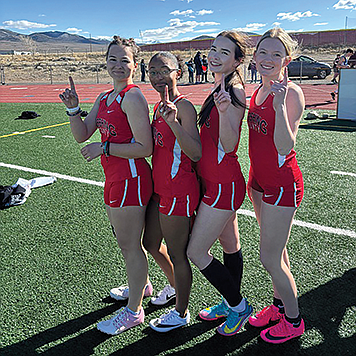 Pershing County’s Chelsea Woodard, Kenya Vaughan, and Hayley and Khloe Montes celebrate their relay win at the Dust Devil Invite.