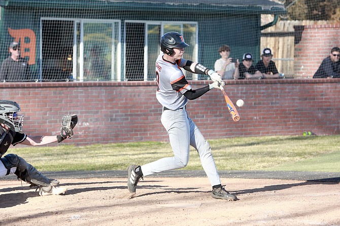 Douglas High’s Jackson Ovard connects with a pitch Tuesday afternoon against Galena. Ovard was 1-for-2 with a walk in the Tigers’ 7-4 win over the Grizzlies