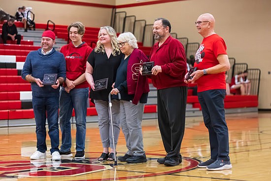 Snohomish High School 2023 Hall of Fame inductees were honored during the halftime of the Jan. 30 basketball game. From left to right: Josh and Cash Larson on behalf of Dr. Leeon Aller, Erin Aber and Clara Jean Heirman on behalf of Bob Heirman, Bill Holt for Bill Holt, and Alan Troupe on behalf of Dr. Nancy Butler.