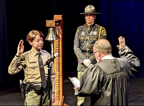 Sheriff Susanna Johnson is sworn in to office Jan. 2 inside the PUD Auditorium in Everett. The event was “packed,” attendee Tom Merrill of Snohomish said.