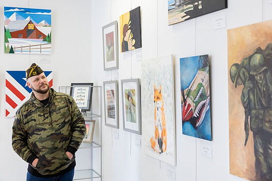 VFW Post 7511 member Jeremy Blake views artwork hanging at the VFW Art Gallery grand opening in Monroe on Feb. 3. Blake, a member of the Army Infantry, has been involved with VFW Post 7511 for a year.