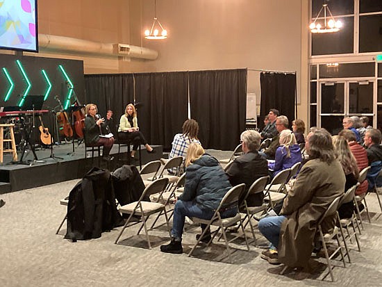 Volunteers of America representatives present to the neighborhood at a meeting about the shelter plans held the evening of Tuesday, Nov. 21, 2023 in Northshore Church in the neighborhood.