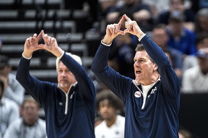 Nevada head coach Steve Alford, right, calls out to his players during the first half against Dayton on March 21.