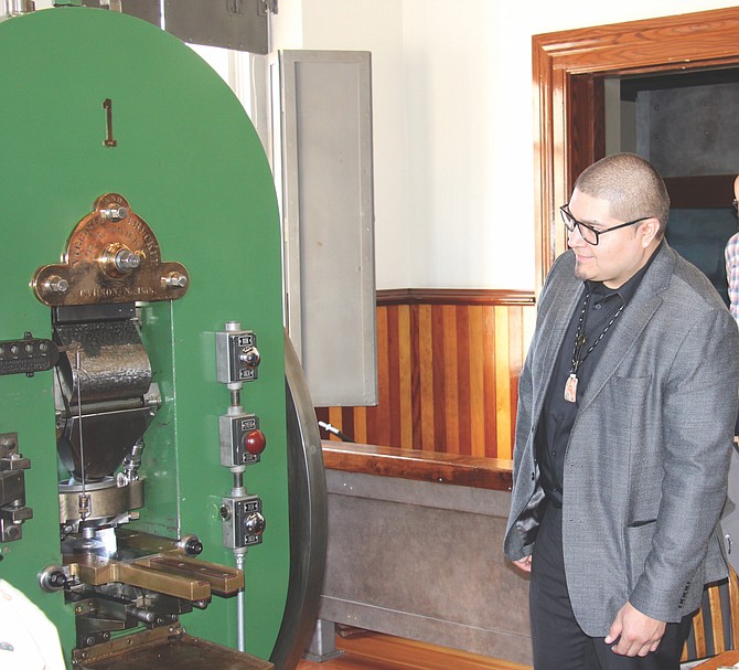 Washoe Tribe Vice Chairman Patrick Burtt looking at Coin Press No. 1 in the Nevada State Museum on March 20.