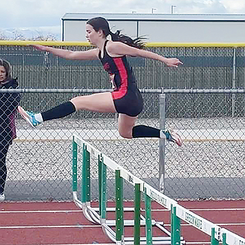 Pershing County’s Hayley Montes jumps in the 300-meter hurdles in Fallon last Saturday.