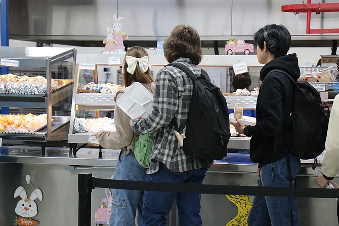 Carson High School students pick up lunch in the school’s downstairs cafeteria Monday. After four years, state funding for free school meals is ending and the Carson City School District is asking families to apply for free and reduced meals before May 24.