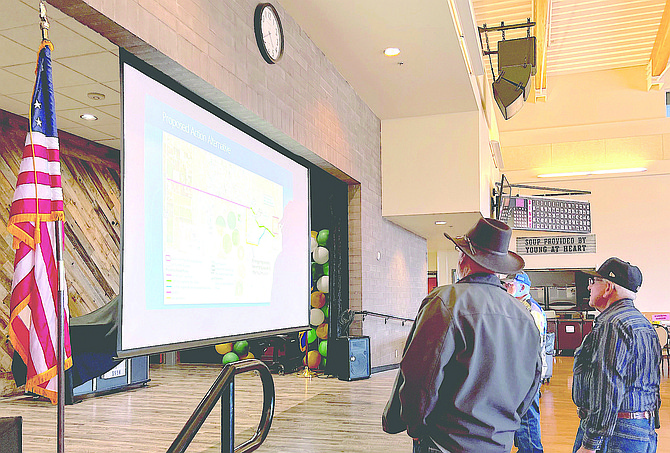 Residents look at a map of the area around the proposed Painted Rock Mine at a Wednesday night presentation by the Bureau of Indian Affairs at the Douglas County Community & Senior Center.